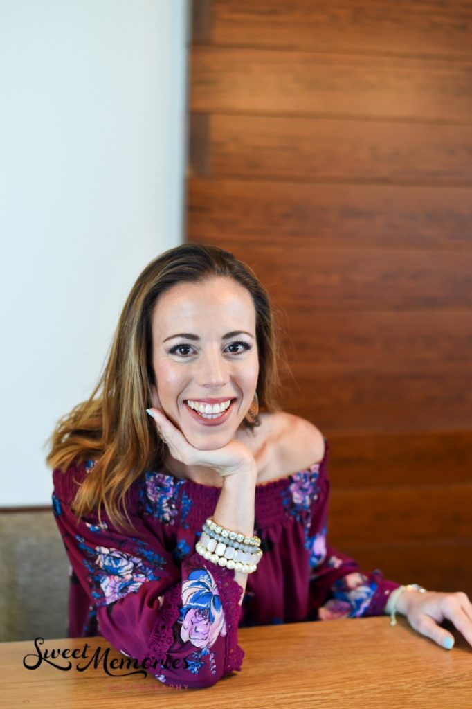 business headshot at coffee shop showing off jewelry on wrist and floral print on shirt